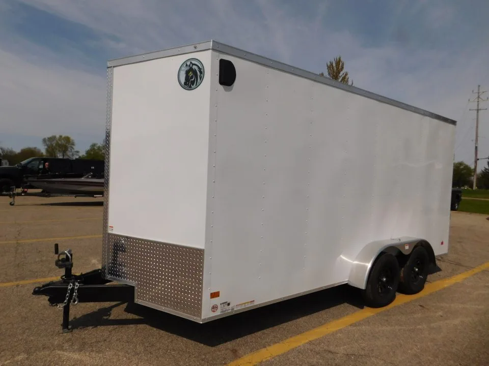 White Darkhorse Cargo enclosed trailer with the horse-head badge on the lot at Holland Trailer in Zeeland, Michigan