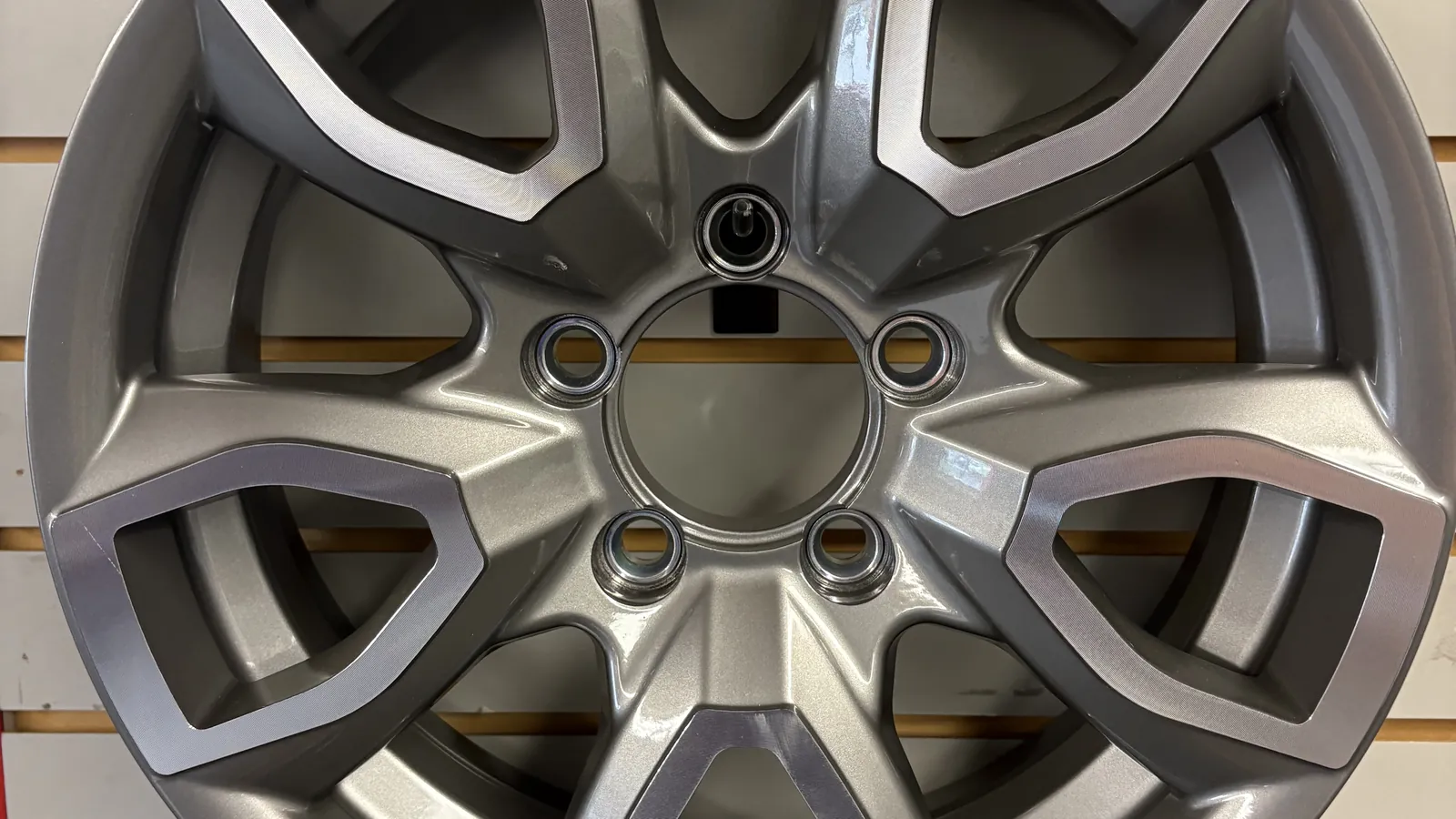 Silver machined aluminum trailer wheel available at Holland Trailer