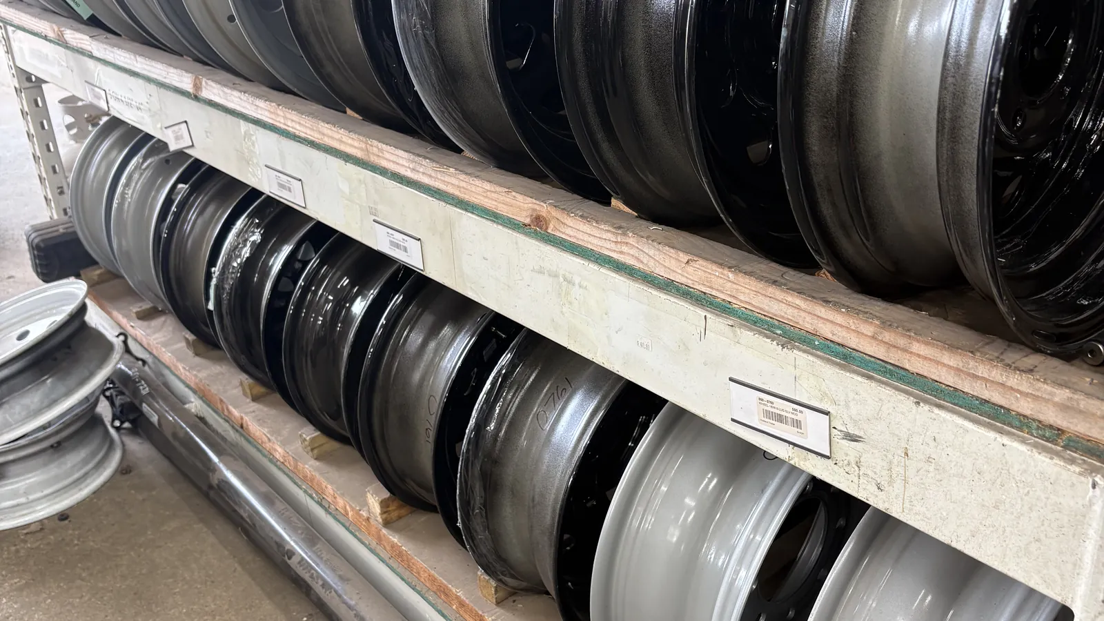 Steel trailer wheels racked by size at Holland Trailer in Zeeland, MI